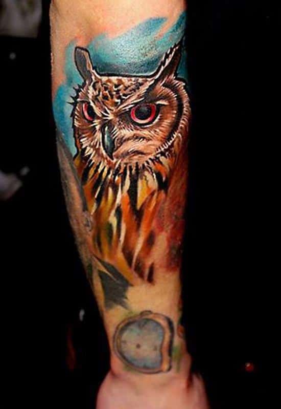 colorful owl tattoo on arm