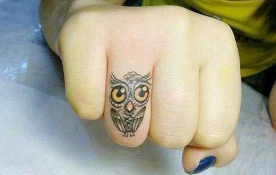 ring finger owl tattoo