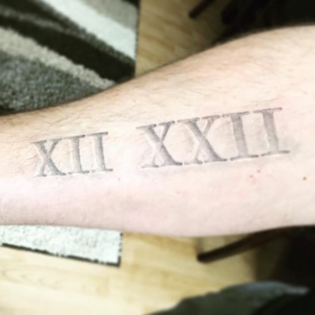 Carved Roman Numeral Tattoo