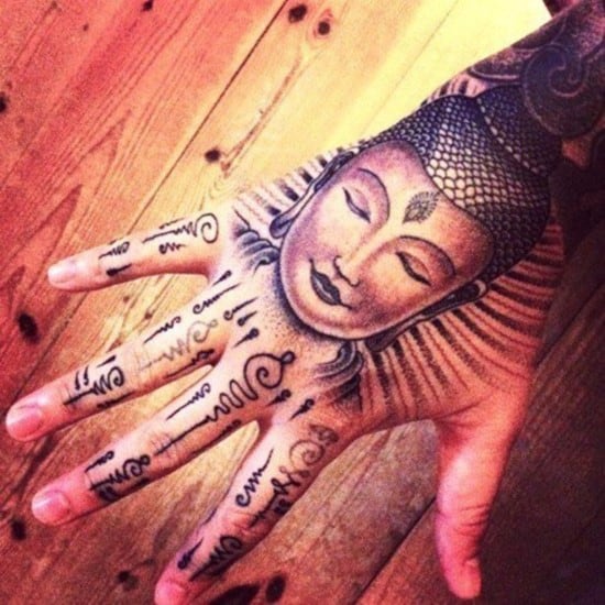 buddhist symbols and buddha tattoo on hand Buddhist-Tattoos-Tumblr