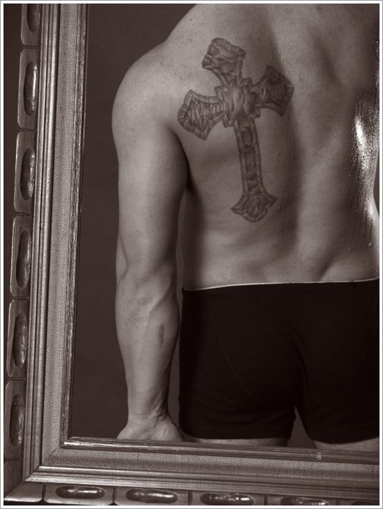 male with cross tattoo in a frame
