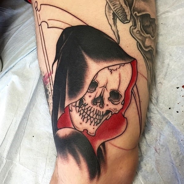 Grim reaper tattoo on the thigh