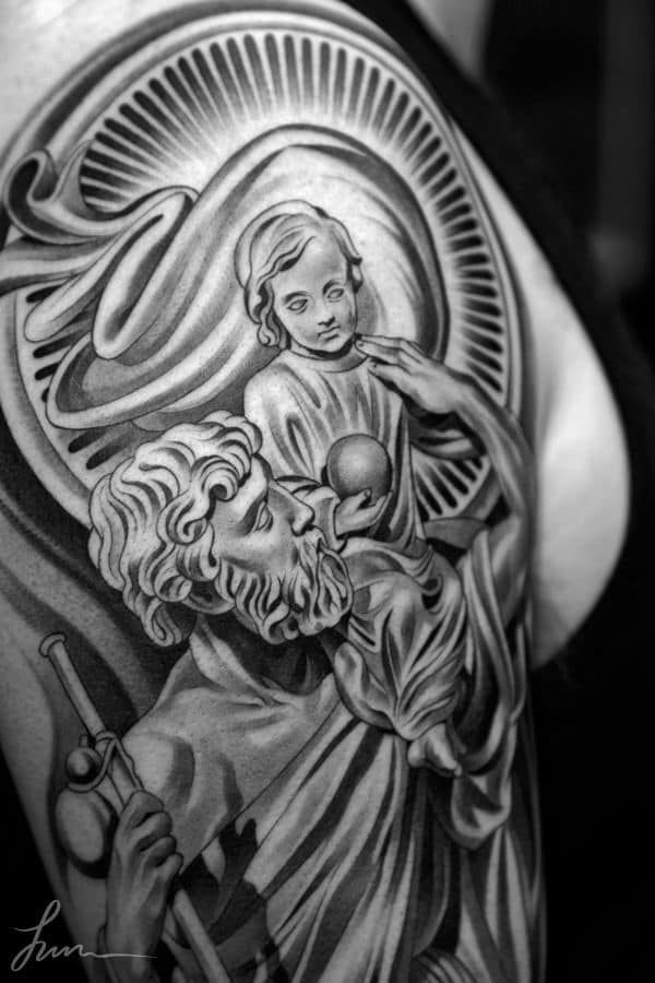 St-Christopher-Juncha. black and white father and son tattoo on arm. 
