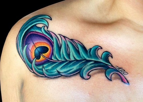 Blue Peacock Feather With Heart Upper Chest Tattoo