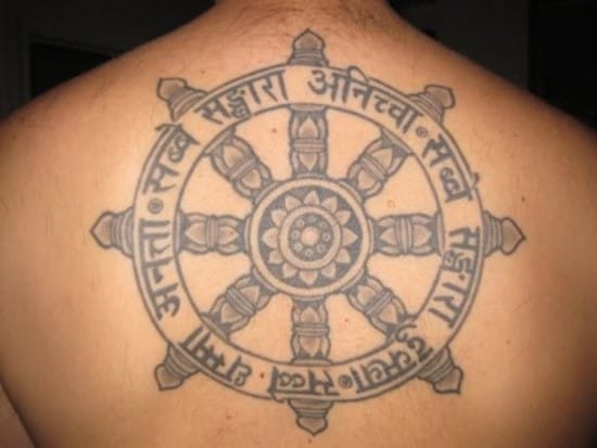 ship wheel with buddhist symbols tattoo on back buddhist-tattoos1