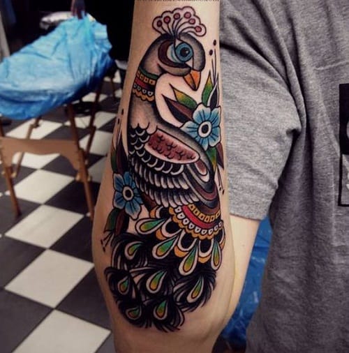 Colorful Peacock On Lower Arm Tattoo
