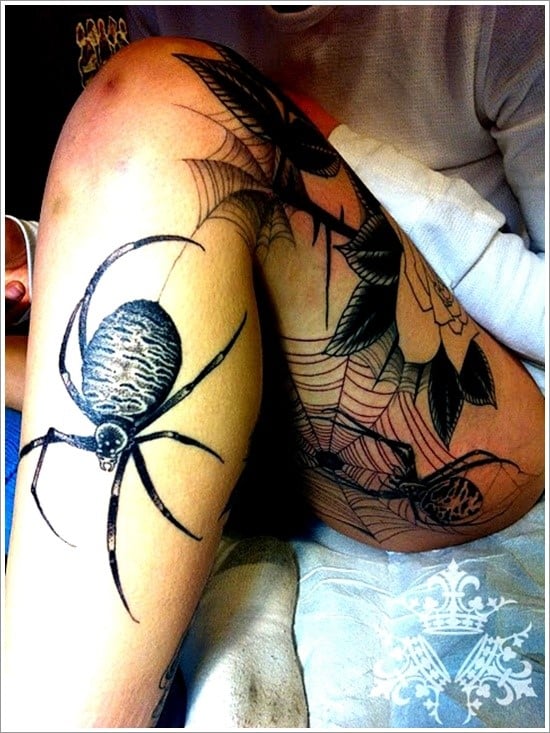 large spider tattoo on leg