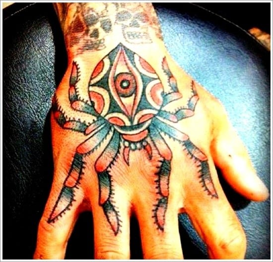 colorful spider tattoo on hand