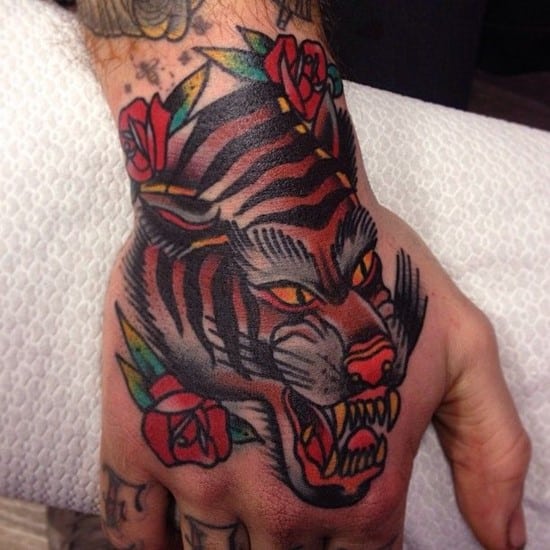 tiger with rose on hand tattoo