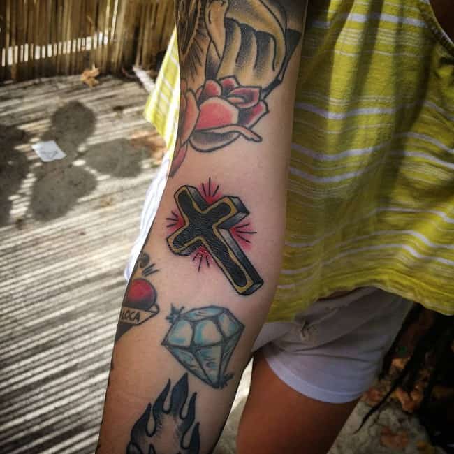 small cross on arm