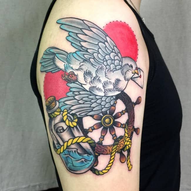 dove and wheel arm tattoo