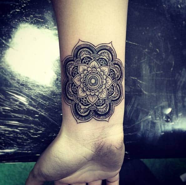 Beautiful mandala flower on wrist by Isaiah Negrete