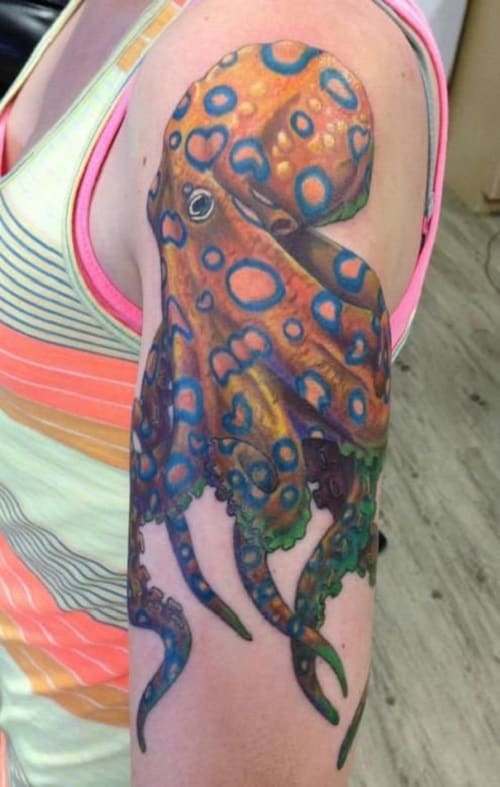 Orange Octopus Tattoo With Circular Designs