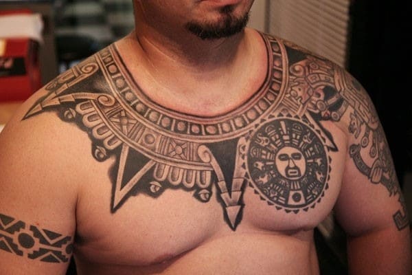 Polynesian style chest and shoulder tattoo