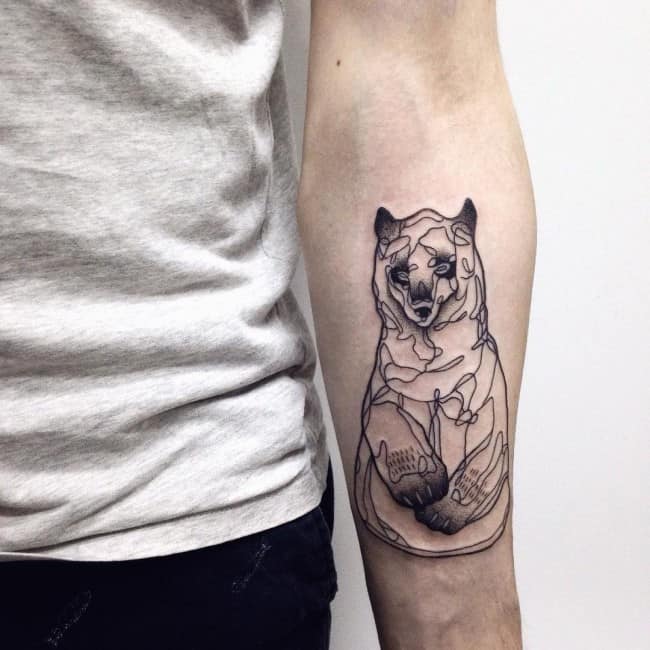 small bear tattoo on arm