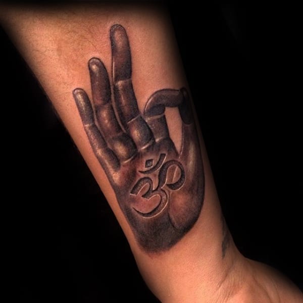 Hand With Okay Sign And Om Tattoo On Mans Forearm