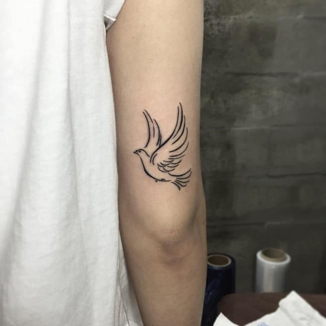 mini dove tattoo on elbow