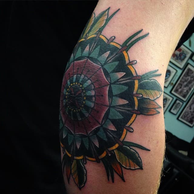 Elbow tattoo of a mandala by tattoo artist André de