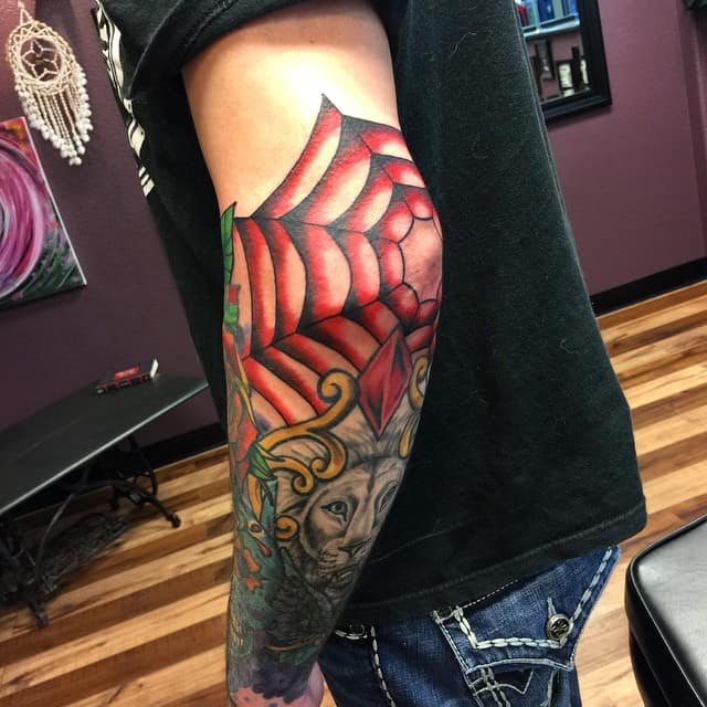 spider web tattoo on elbow for men