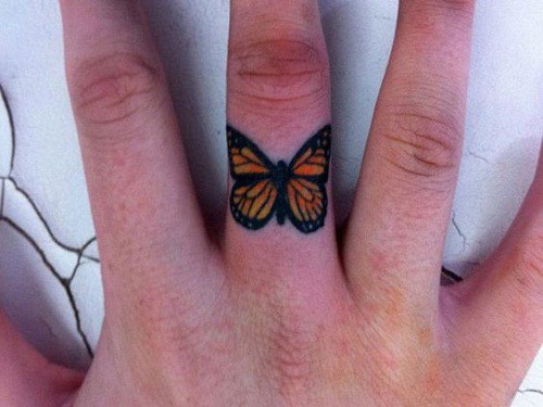 Orange Butterfly on Middle Finger Tattoo
