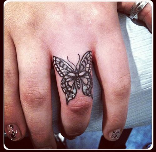 tattoo of a butterfly on finger