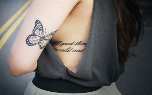 Small Butterfly on Upper Back Arm Tattoo