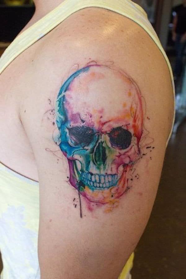 small sugar skull tattoo behind the ear