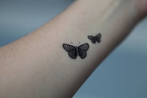 Two Small, Detailed Butterfly Tattoos on Arm