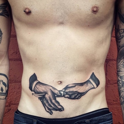 Stabbed Hand Stomach Tattoo