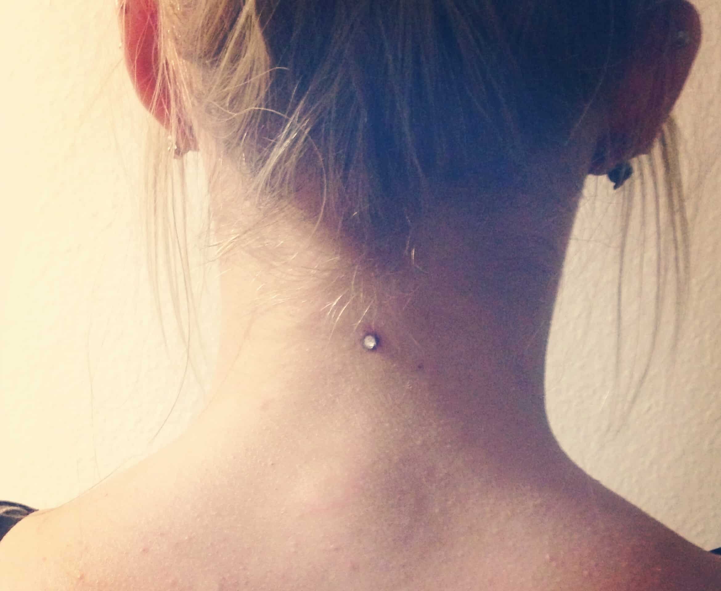 Single Dermal Anchor Nape Piercing Picture For Girls. 