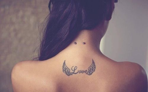 Winged Love Word Tattoo On Upper Back And Surface Nape Piercing