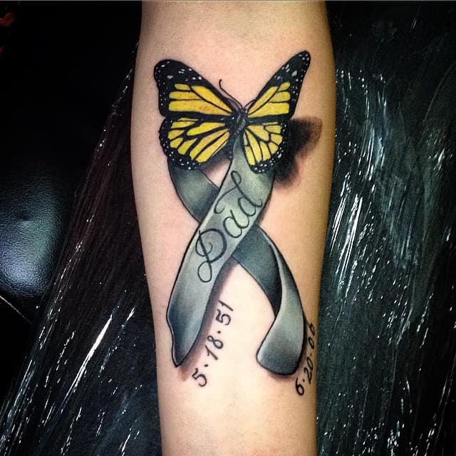 ribbon tattoo on forearm