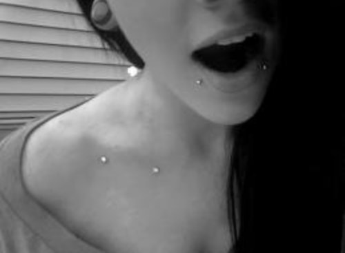 Girl With Lower And Collar Bone Piercings