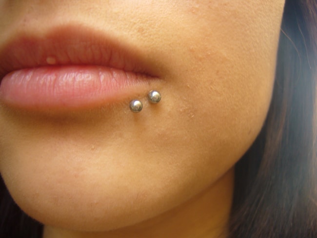 Silver Barbells Spider Bite Piercing On Lower Lip