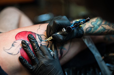 tattooist drawing a tattoo