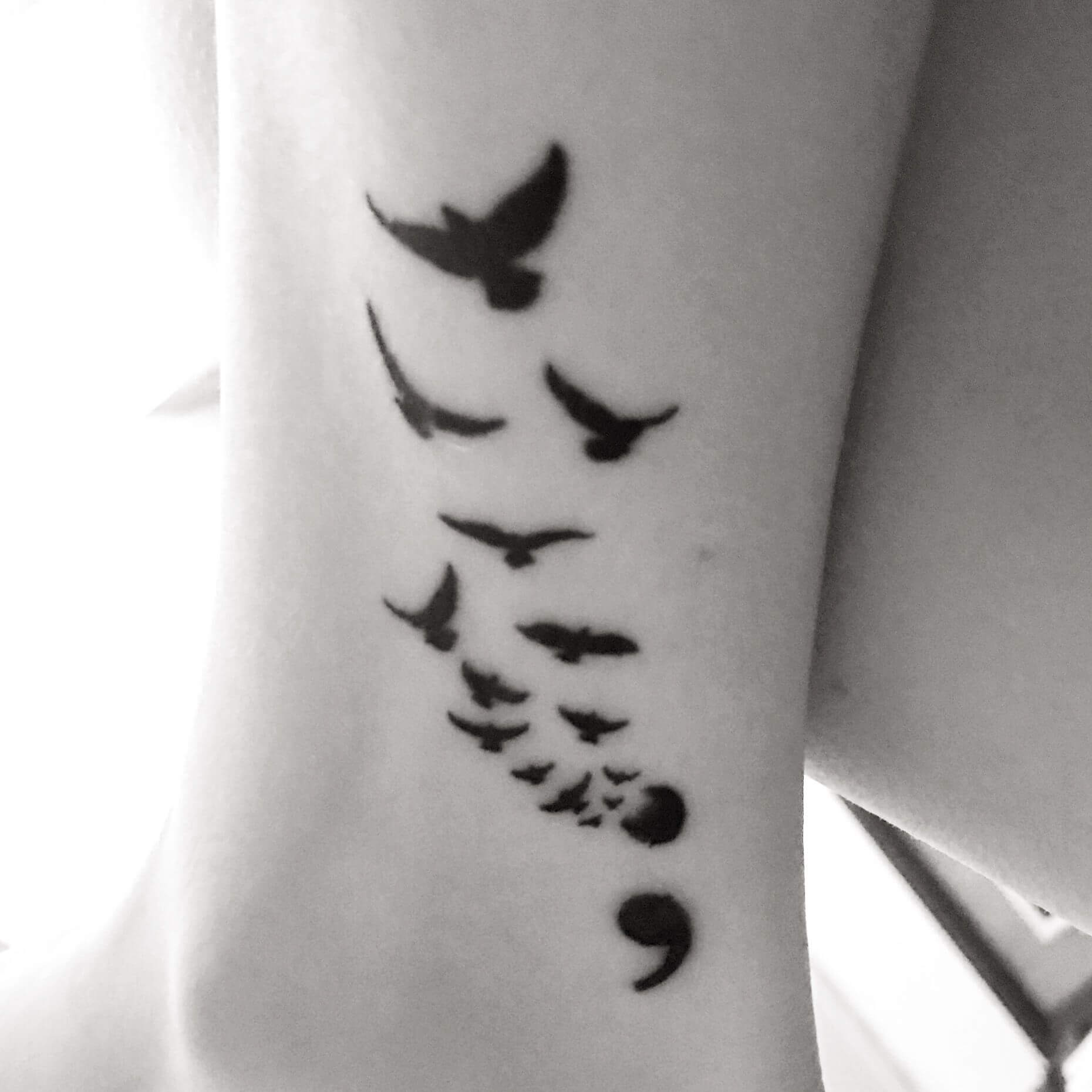 bird semicolon tattoo on leg
