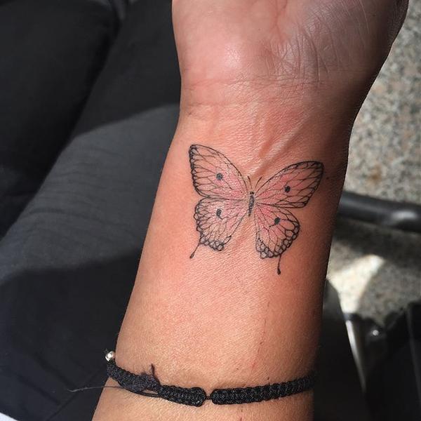 butterfly semicolon tattoo on wrist