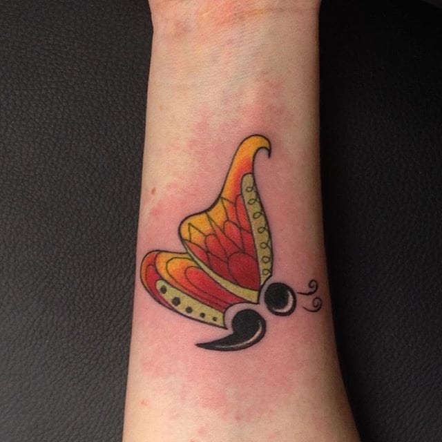 butterfly semicolon tattoo on arm