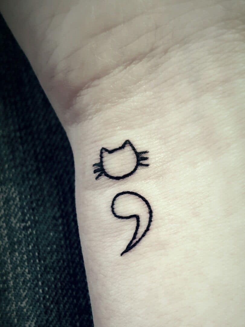 cat semicolon tattoo on wrist