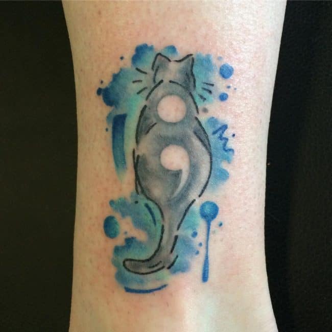 cat semicolon tattoo on arm