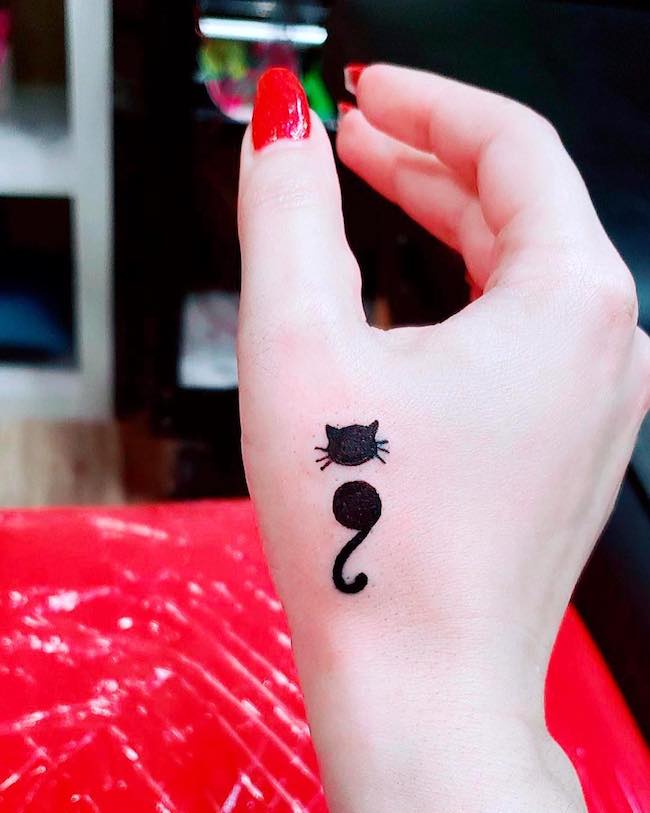 cat semicolon tattoo on hand
