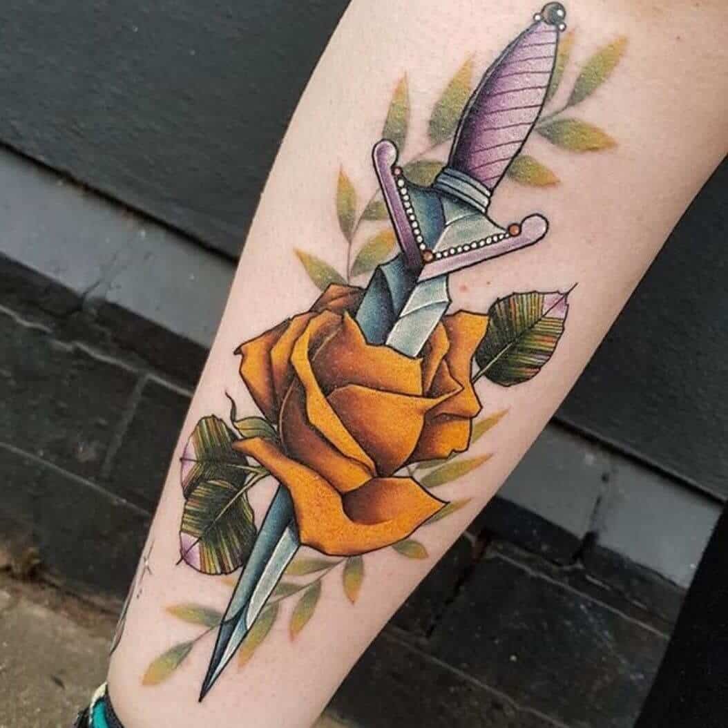 dagger and rose tattoo on leg