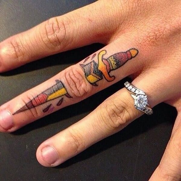 Small Dagger Tattoo On Finger