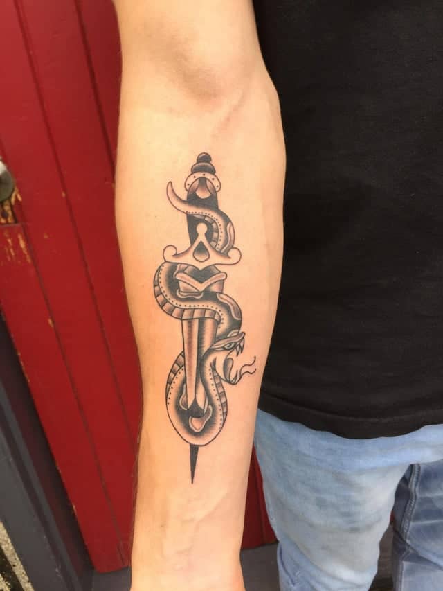 dagger tattoo on arm