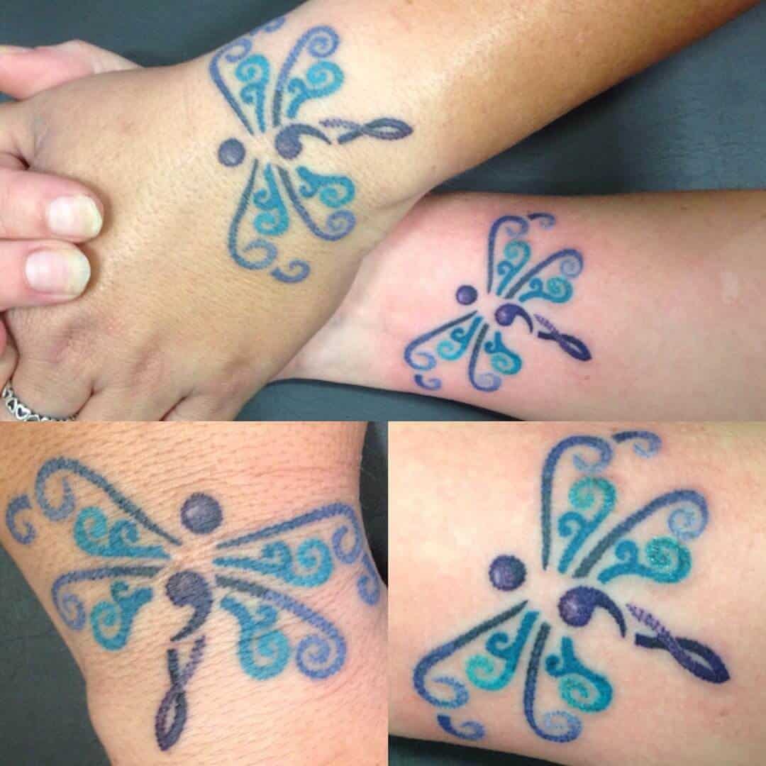 dragonfly semicolon tattoo on hand