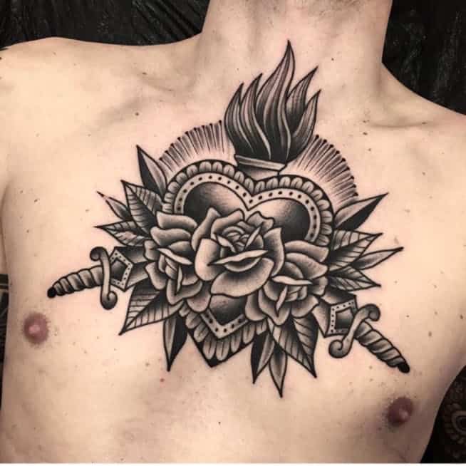 heart and dagger tattoo on chest