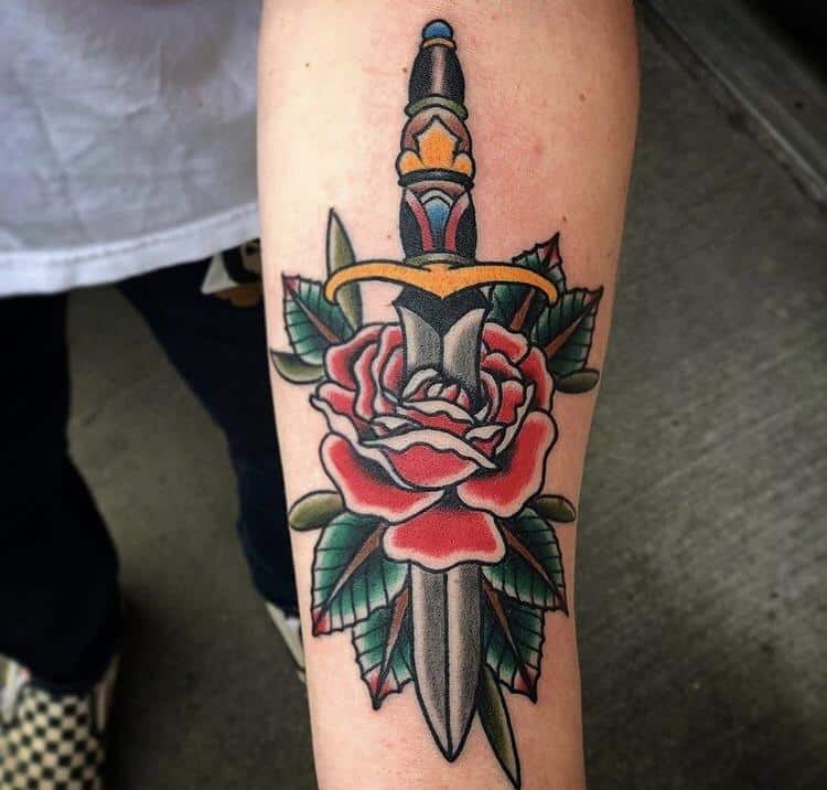 heart and dagger tattoo on arm
