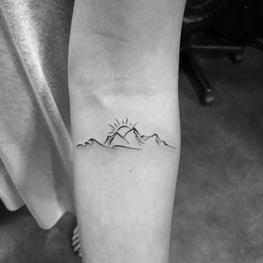 mountain tattoo on arm