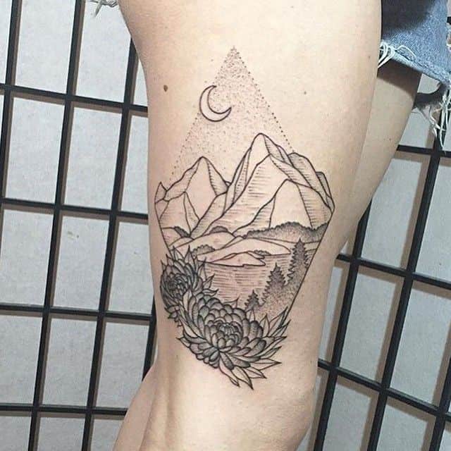 mountain tattoo on thigh