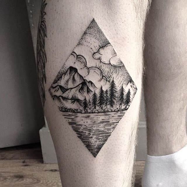 mountain tattoo on leg